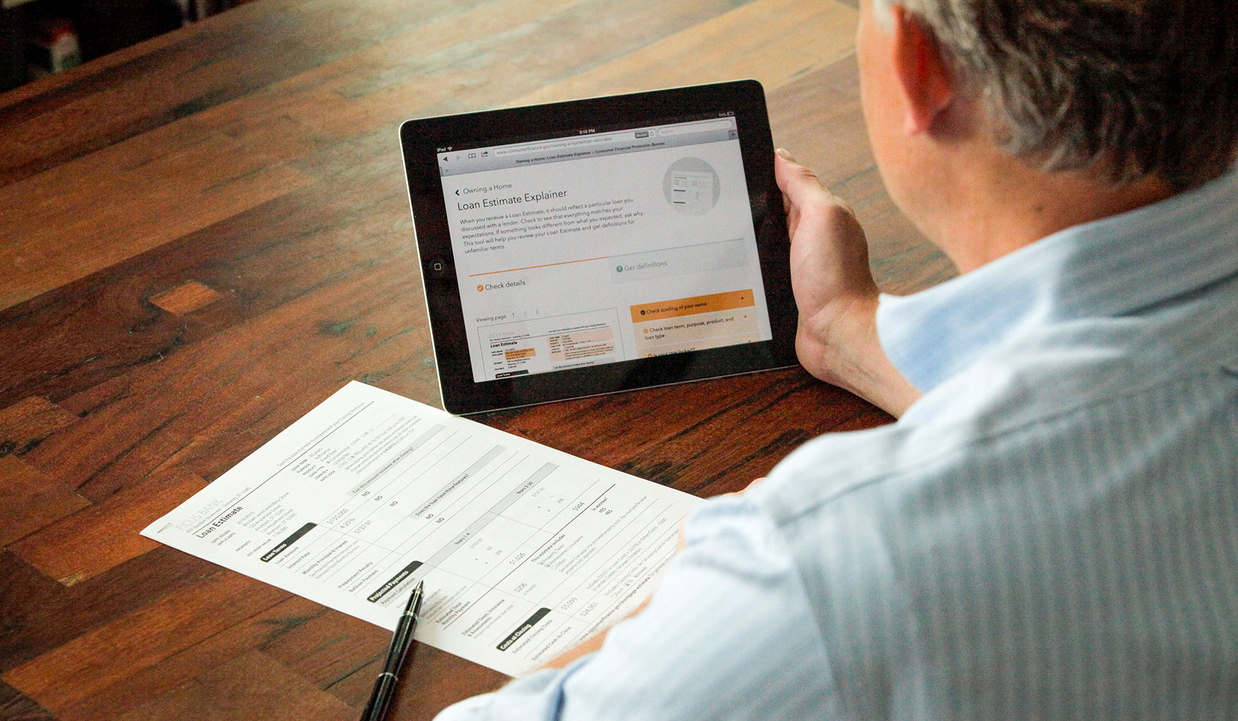 Man looking at a closing form and an iPad